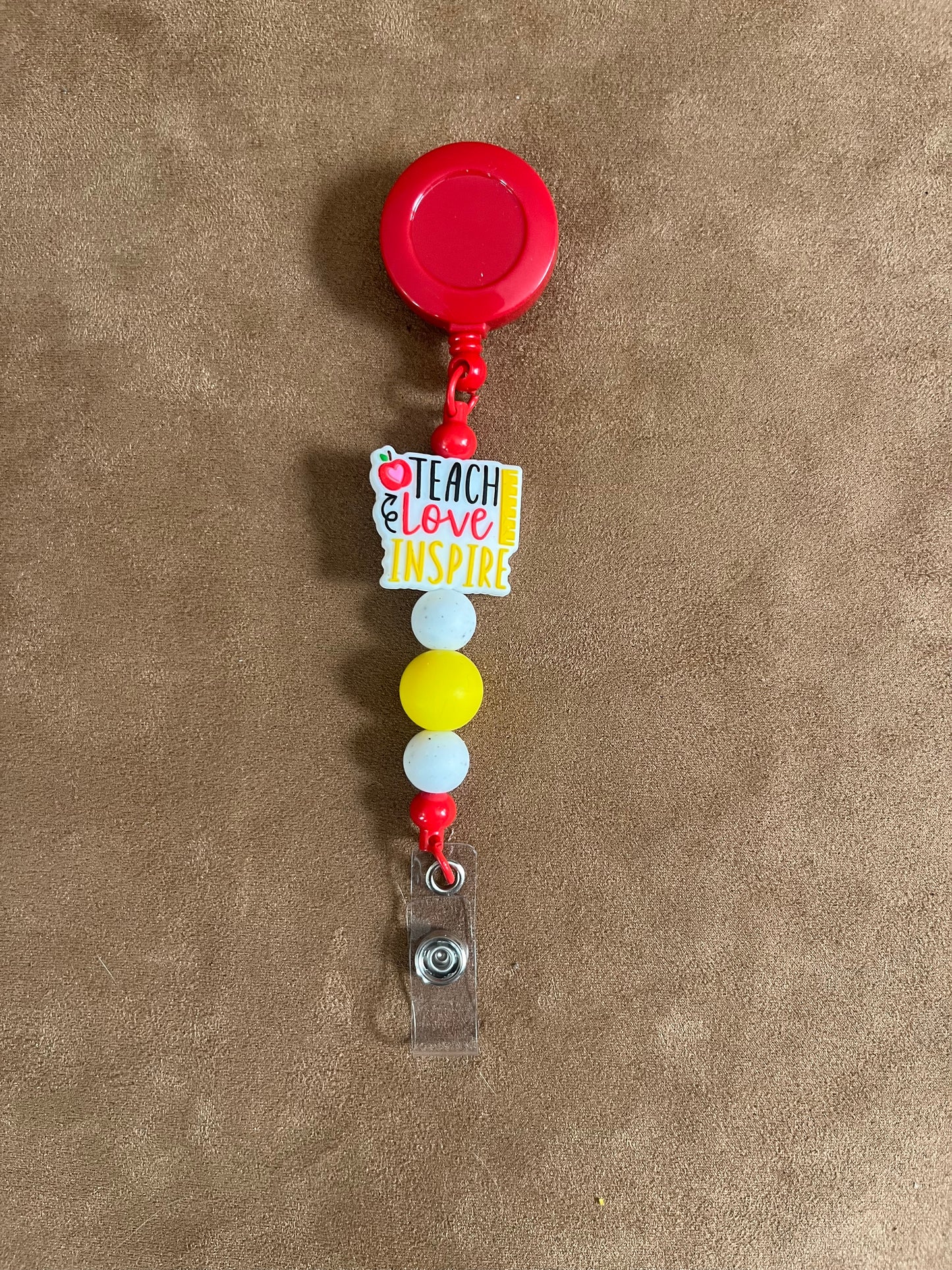 Red and Yellow Teach Love Inspire Badge Reel