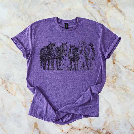 Purple t-shirt with horse graphic on a marble surface